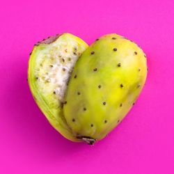 High angle view of apple against pink background