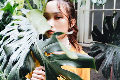 Portrait of young woman with leaves