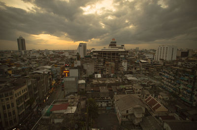 High angle view of buildings in city against sky during sunset