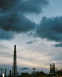 Low angle view of construction site against cloudy sky