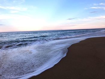 Scenic view of beach against sky during sunset