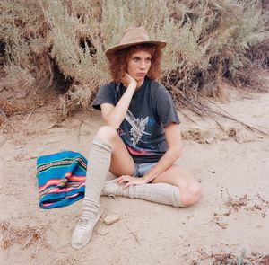 Portrait of young woman sitting on bench