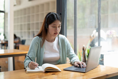 Portrait of young businesswoman working at office