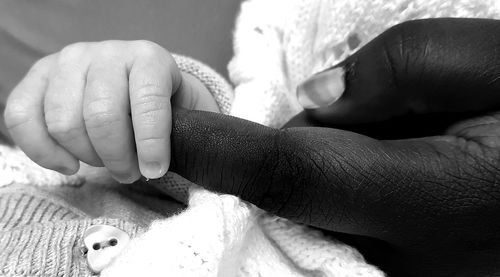 Close-up of baby holding finger