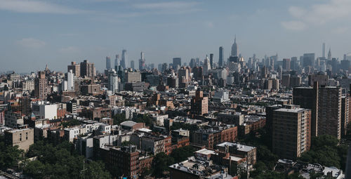 Aerial view of modern buildings in city against sky