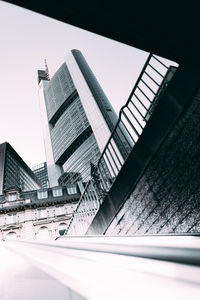 Buildings in city against clear sky