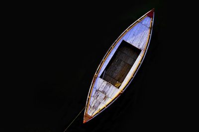 Low angle view of boat moored against black background