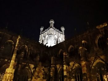 Low angle view of statue of historic building at night