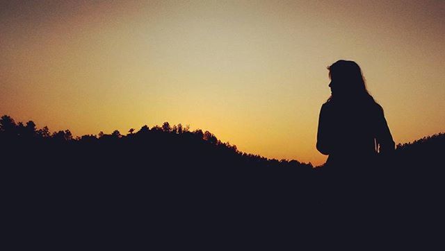 silhouette, sunset, copy space, standing, lifestyles, orange color, three quarter length, leisure activity, beauty in nature, sky, tranquility, clear sky, men, tranquil scene, scenics, nature, waist up, sitting