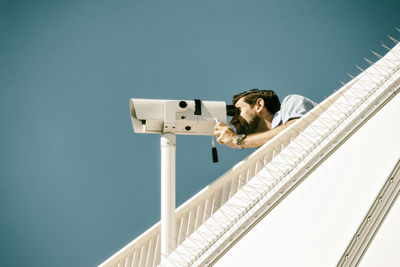 Low angle view of man against clear sky
