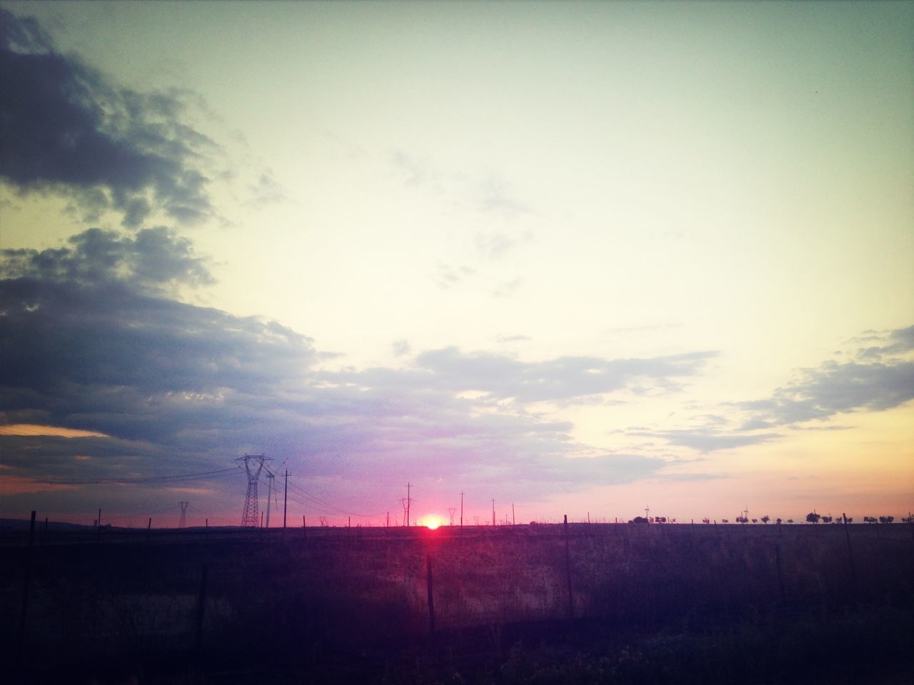 sunset, sun, silhouette, tranquil scene, sky, landscape, scenics, tranquility, beauty in nature, field, nature, orange color, idyllic, sunlight, cloud - sky, sunbeam, cloud, horizon over land, outdoors, rural scene