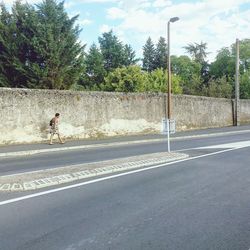 Man on road against trees