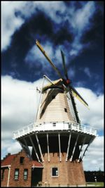 Low angle view of traditional windmill against clear sky