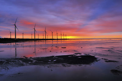 Scenic view of beach against sky during sunset