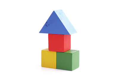 Stack of multi colored toy on white background