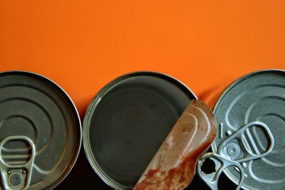 High angle view empty can against orange background