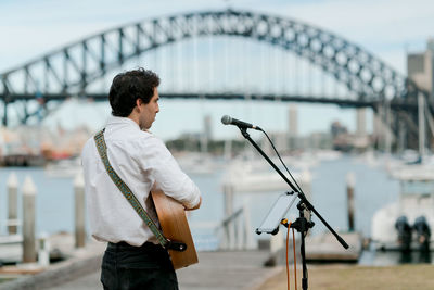 Full length of man standing on bridge