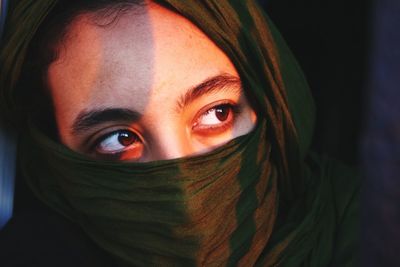 Close-up of teenage girl face covered with textile