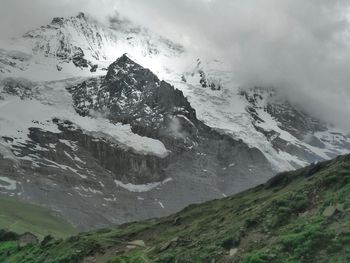 Scenic view of mountains against cloudy sky