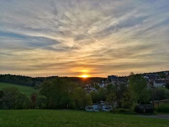 Scenic view of field against sky during sunset