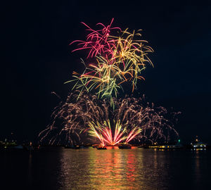 Low angle view of firework display at night