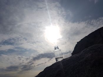 Low angle view of bottle against sky