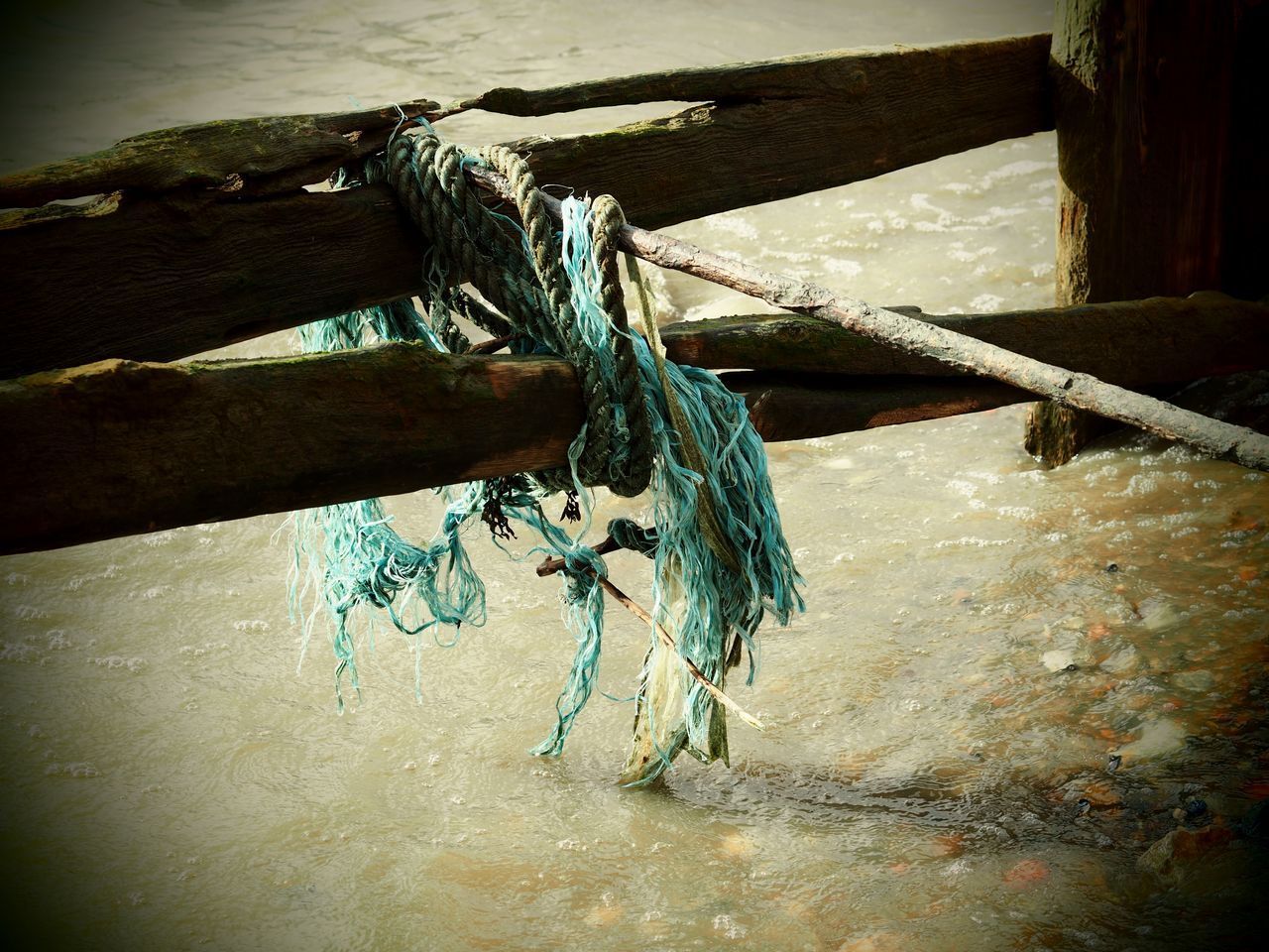 CLOSE-UP OF TIED HANGING ON ROPE