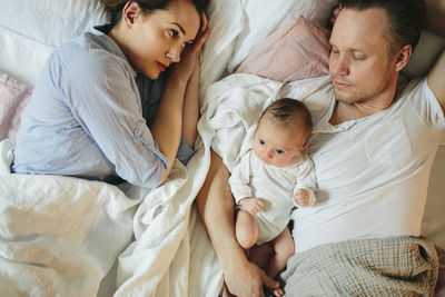 Parents with baby in bed