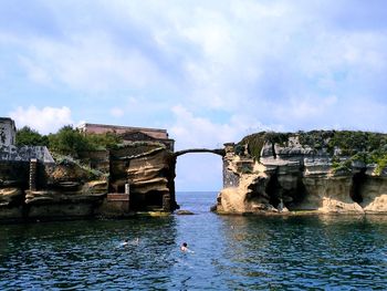 Scenic view of rock cliff against sky