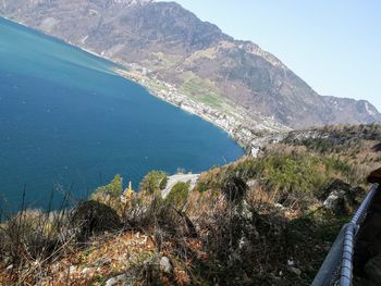 High angle view of lake and mountains against sky