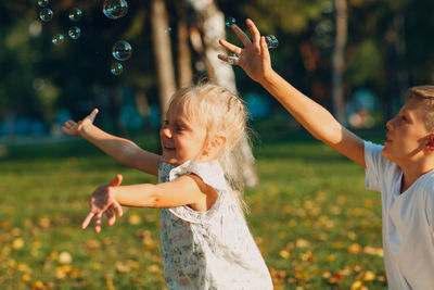 Siblings playing on land