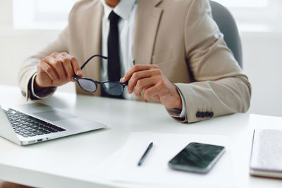 Midsection of doctor working at table