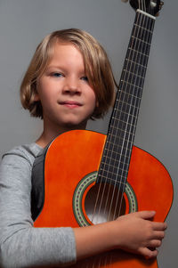 Portrait of a girl playing guitar