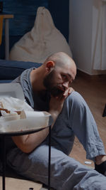 Young man sitting at home