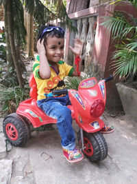 Portrait of boy playing with toy car