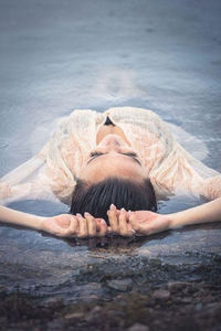 Portrait of woman lying in water