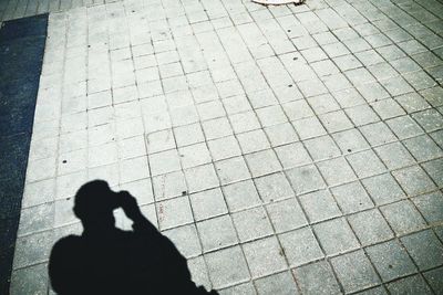 Silhouette man on zebra crossing