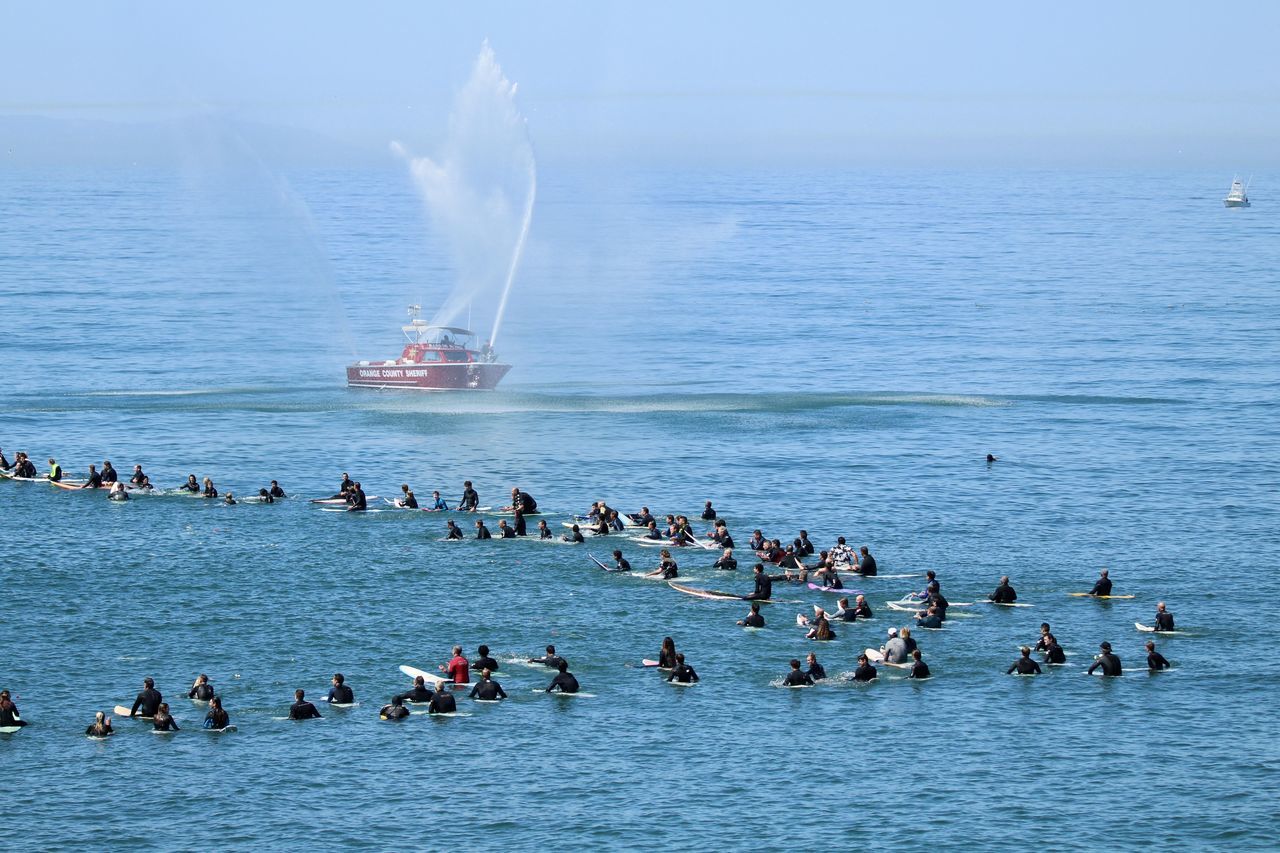 GROUP OF PEOPLE ON BOATS IN SEA