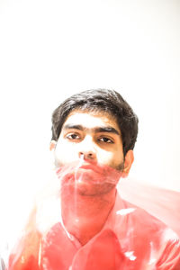 Portrait of young man against white background