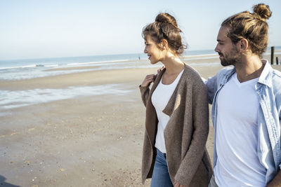 People on beach against sky