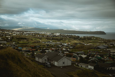 Houses by mountains against sky