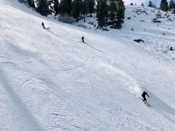 People skiing on snowcapped mountain