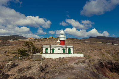 Building on mountain against sky