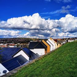 Houses on field against sky