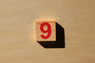 Close-up of number 9 on wood