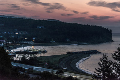 High angle view of road by sea against sky at sunset