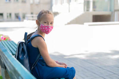 Portrait of girl sitting outdoors