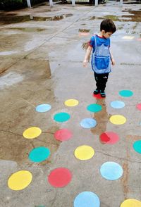 High angle view of girl standing on footpath