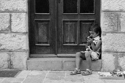 Full length of boy playing in front of building