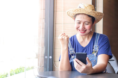 Portrait of smiling young man using mobile phone